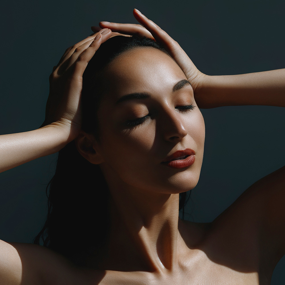 Woman with nice skin holding her head